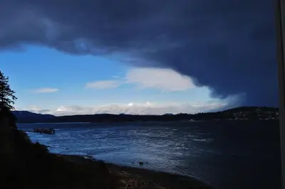a view of a body of water with a cloudy sky at Above Tide Motel in Campbell River