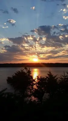 a sunset over a large body of water at Above Tide Motel in Campbell River