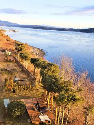 a view of a body of water with a wooden deck at Above Tide Motel in Campbell River