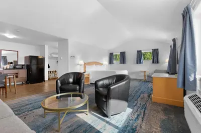 a living room with a bed and a table and chairs at Kootenay Lakeview Resort BW Signature Collection in Balfour