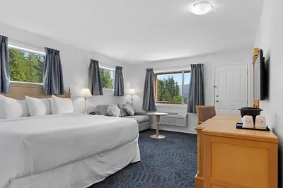 a hotel room with a bed and a couch at Kootenay Lakeview Resort BW Signature Collection in Balfour