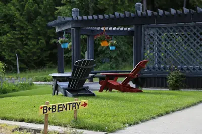 a sign in the grass with chairs and a picnic table at Silver Star Bed and Breakfast in Vernon