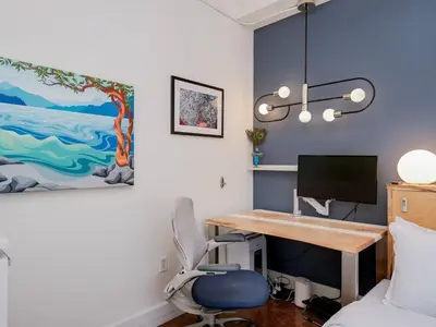 a bedroom with a desk and a bedroom with a bed at Old Town Retreat-your artful escape in Victoria’s historic Old Town by Victoria Prime! in Victoria
