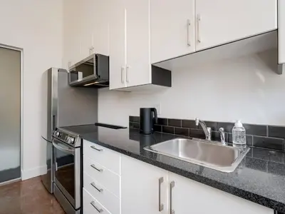 a kitchen with a sink and a microwave at Old Town Retreat-your artful escape in Victoria’s historic Old Town by Victoria Prime! in Victoria