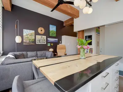 a kitchen and living room with a wooden counter top at Old Town Retreat-your artful escape in Victoria’s historic Old Town by Victoria Prime! in Victoria