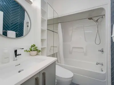 a bathroom with a sink and a toilet and a mirror at Old Town Retreat-your artful escape in Victoria’s historic Old Town by Victoria Prime! in Victoria