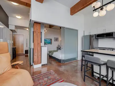 a room with a kitchen and a living room at Old Town Retreat-your artful escape in Victoria’s historic Old Town by Victoria Prime! in Victoria