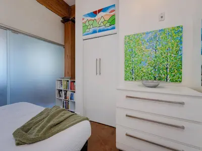 a bedroom with a bed and a window at Old Town Retreat-your artful escape in Victoria’s historic Old Town by Victoria Prime! in Victoria