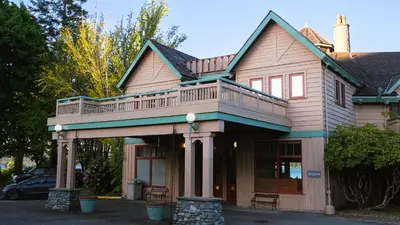 a house with a deck on top of it at Painter's Lodge in Campbell River