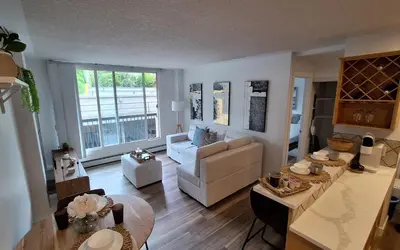 a living room with a couch and a table at Modern 1br Apt, Up to 4 people, Steps to 17th Ave, Downtown & Stampede in Calgary