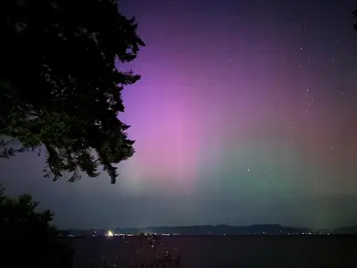 a rainbow in the sky over the water at night at Sea 'N' Stars BNB in Gabriola