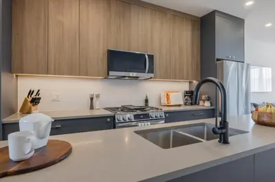a kitchen with a sink and a stove at Upper and Lower, Great for Large Families, Fenced Yard in Calgary