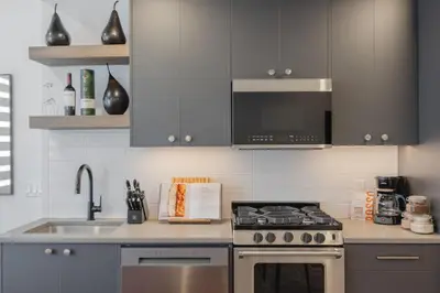 a kitchen with a stove and a sink at Upper and Lower, Great for Large Families, Fenced Yard in Calgary