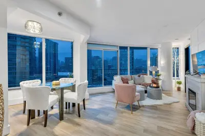 a living room with a table and chairs and a couch at Modern 2BR 2BA Condo in Heart of Vancouver in Vancouver