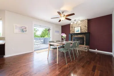 a dining room with a table and chairs and a fireplace at Surrey Family Home w/ Patio & Garden – 3BR 2BA in Surrey