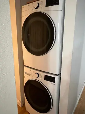 two microwaves stacked on top of each other at Cozy Riverdale Home in Whitehorse