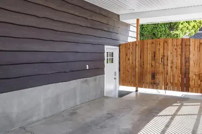 a house with a wooden wall and a door at Knox Mountain Vista 2 Bdrm Suite in Kelowna