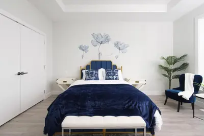 a bedroom with a blue bed and a blue chair at Modern 3BR Near Langley Events Centre & EV charger in Langley