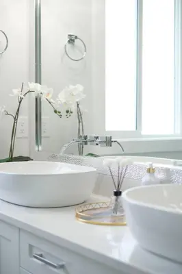 a white bathroom with two sinks and a mirror at Modern 3BR Near Langley Events Centre & EV charger in Langley