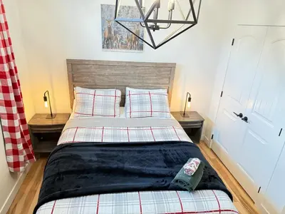 a bedroom with a bed and two night stands at Rustic Rocky Retreat in Calgary
