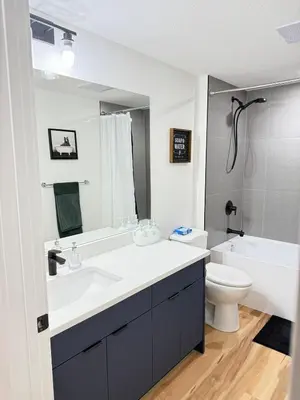 a bathroom with a white sink and a toilet at Rustic Rocky Retreat in Calgary