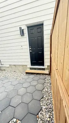 a black door on the side of a house at Rustic Rocky Retreat in Calgary