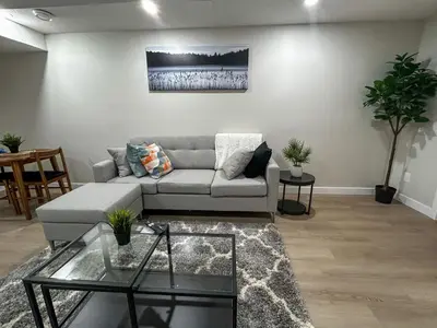 a living room with a couch and a glass table at Eli's Place in Calgary