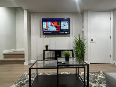 a living room with a tv on a wall at Eli's Place in Calgary