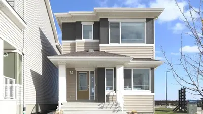 a white house with a front door and windows at stylish 5-Star Suite 1BD 1 Bath Le Reve Beaumont in Nisku