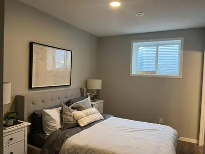 a bedroom with a bed and a window at stylish 5-Star Suite 1BD 1 Bath Le Reve Beaumont in Nisku