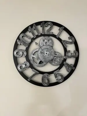 a metal clock on a wall on a wall at Full Luxury home 4 BD ,AC,sleep 14,BBQ, 2V Garage in Edmonton
