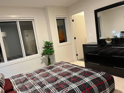 a bedroom with a bed and a dresser and a piano at Full Luxury home 4 BD ,AC,sleep 14,BBQ, 2V Garage in Edmonton
