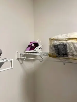 a shelf with a helmet on it next to a bed at Full Luxury home 4 BD ,AC,sleep 14,BBQ, 2V Garage in Edmonton