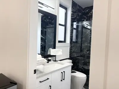 a bathroom with a sink and a toilet at Bird Nest Suites in Surrey