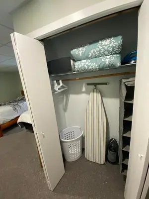 a closet with a door open with a baseball bat at Blind Bay Chalet 2 Bedroom Private Suite in Blind Bay