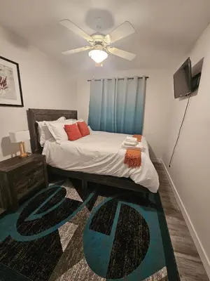 a bedroom with a bed and a ceiling fan at Aansel Suites 2 bedroom in Edmonton