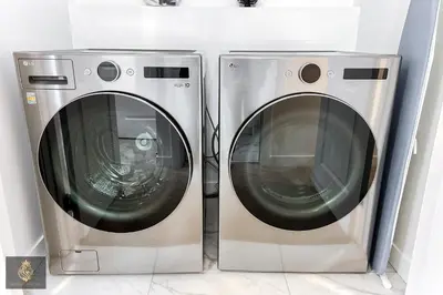 two washing machines are sitting next to each other at FreshModernWEMGarageKingBed in Edmonton
