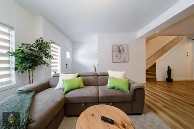 a living room with a couch and a table at FreshModernWEMGarageKingBed in Edmonton
