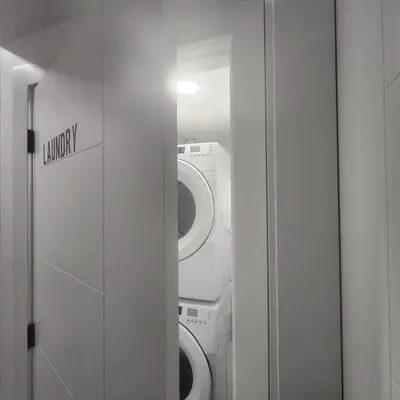 a bathroom with a washing machine and a mirror at Spacious 2 Bedroom Suite in Edmonton, Canada in Edmonton