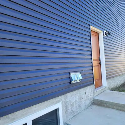 a blue wall of a house with a door at Spacious 2 Bedroom Suite in Edmonton, Canada in Edmonton
