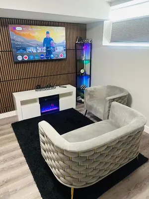 a living room with a couch and a tv at True Haven in Prince George