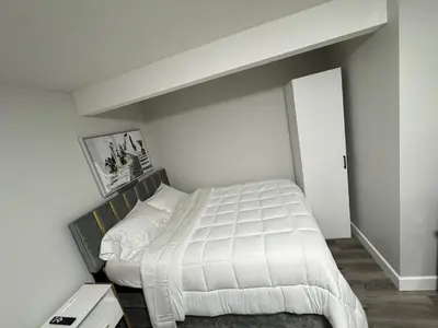 a bedroom with a large white bed in it at True Haven in Prince George