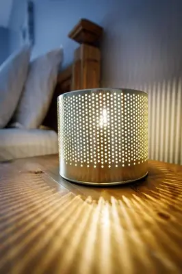 a silver lamp sitting on top of a wooden table at Ha Ling Haven - Penthouse with Shared Rooftop Hot Tub in Canmore