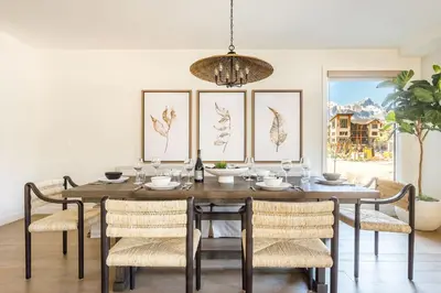 a dining room with a wooden table and chairs at Creekside Elegance at Timberstone in Canmore
