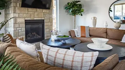 a living room with a couch and a table at Creekside Elegance at Timberstone in Canmore