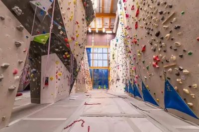 a large room with a wall of climbing equipment at Mountainside - Stunning Views Downtown Location in Canmore