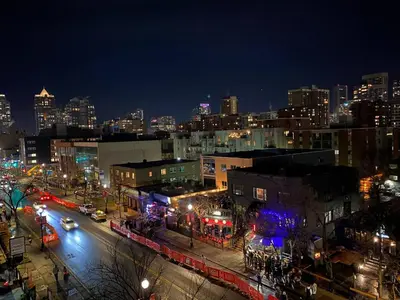 a view of a city at night with lights at Stay Heart of Calgary, Enjoy Night Life, Free Parking Incl in Calgary