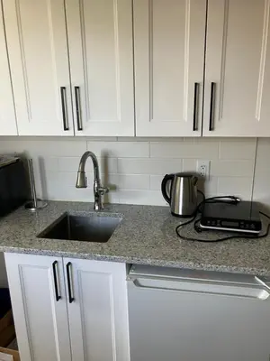 a kitchen counter with a sink and a toaster at Welcome to the Cozy Studio in Kelowna