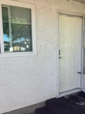 a white door and a window on a house at Welcome to the Cozy Studio in Kelowna