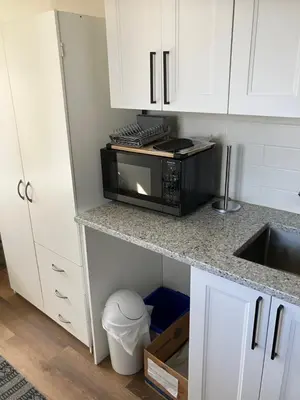 a kitchen with a counter top with a microwave at Welcome to the Cozy Studio in Kelowna